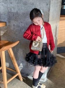 Detail of girls' gold sequin handbag with pearl handle and snowflake charm decoration