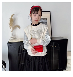 Detail of red small square crossbody chain bag paired with girls retro autumn outfit