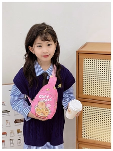 Detail view of pink Capybara chest bag with cartoon print worn by a young girl