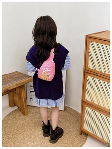Pink Capybara chest bag worn by a child in a cozy home setting showing adjustable strap