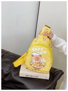 Detail of cute yellow Capybara cross body chest bag with cartoon print and front zipper
