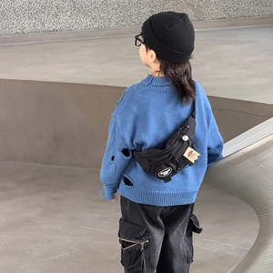 Kids black nylon chest bag with fashion logo on model at industrial stairs