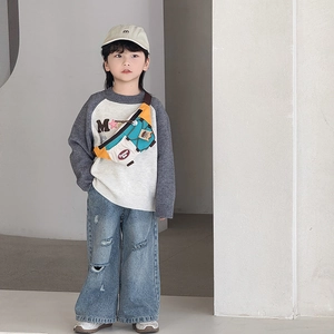 Kids casual crossbody bag with contrast colors paired with knit sweater and jeans