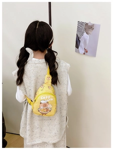 Rear view of child wearing a yellow Capybara chest bag with adjustable strap and cartoon print