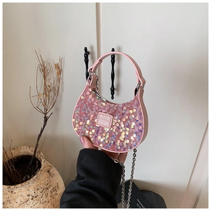 Detail of pink sequin girl's crossbody bag with metal chain strap and leather handle