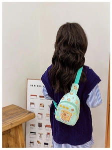 Detail view of mint green cartoon shoulder bag with adjustable strap and bear prints
