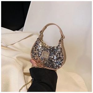 Detail of a mini glitter handbag for girls featuring gold sequins and metal chain strap