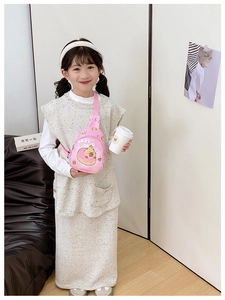 Pink child crossbody bag with cartoon capybara print shown worn by a toddler model