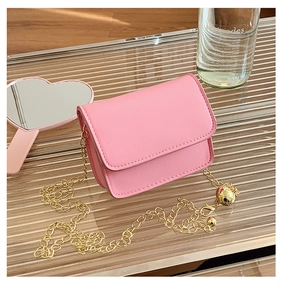 Detailed view of pink mini crossbody bag with golden chain strap and sphere buckle