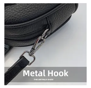 Detail of high-quality black lychee leather with durable gun-metal hardware hooks