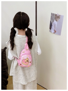 Pink kids crossbody bag featuring a cute cartoon capybara on a donut printed design