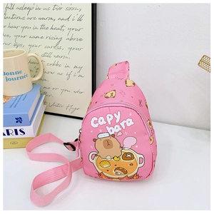 Detailed view of pink Capybara crossbody bag with adjustable strap on a white desk