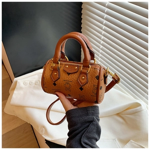 Detail of brown mini Boston bag with bear print, textured leather, and removable strap