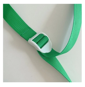 Detailed macro view of durable green nylon strap with white plastic adjustment buckle
