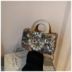Detail of champagne gold sequin handbag with pearl chain and adjustable shoulder strap