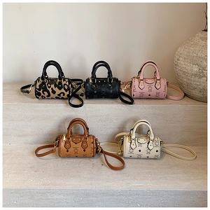 Collection of five mini bear print and leopard barrel bags with detachable straps