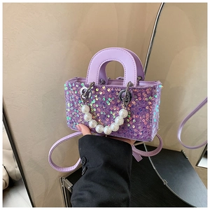 Detail of purple sequin mini bag with pearl chain and detachable shoulder strap