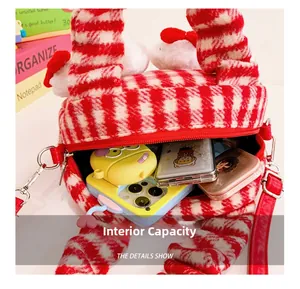Macro shot of internal capacity showing red plaid plush bag with mobile phone and cosmetics