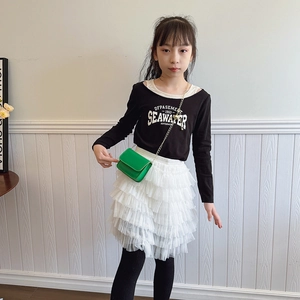 Kids minimalist green crossbody bag paired with black top and white lace cake skirt outfit