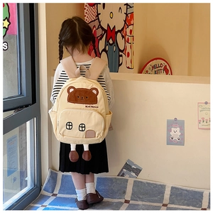 Detail view of a cute bear canvas backpack for kids featuring a house-shaped pocket