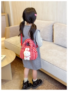 Detail of red plaid plush kids bag with white bunny plush and red shoulder strap