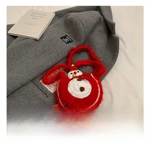 Détail du sac à bandoulière en crochet rouge avec motif bonhomme de neige et clochettes