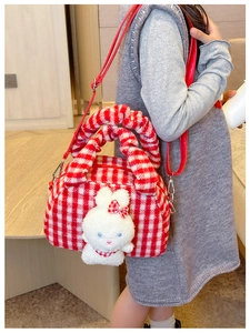 Girl's red checkered crossbody bag with cute plush bunny detail worn on side