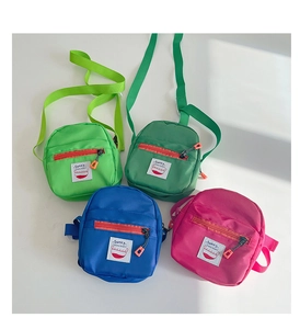 Close-up of vibrant mini crossbody bags for kids featuring multi-zipper and Sunny patch