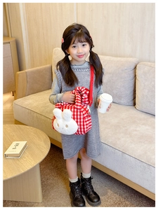 Detail of red checkered plush toddler bag with cute 3D bunny and red fabric strap