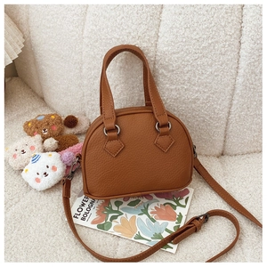 Detail of brown litchi pattern mini shell bag for kids with teddy bear charms