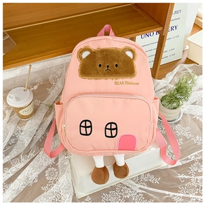 Detail of pink nursery backpack featuring plush bear design and house-shaped stitching