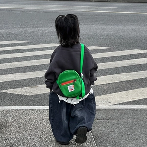 Neon green kids mini crossbody bag with orange zipper and adjustable strap street style