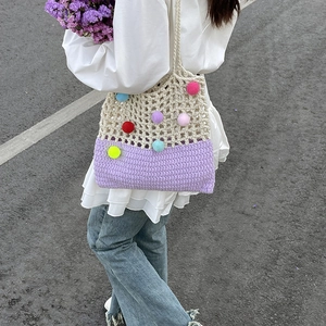 Handmade crochet shoulder bag with colorful pompoms and striped hollow knit design