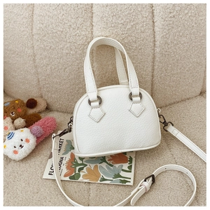 Detail of white lychee texture synthetic leather on a mini shell crossbody handbag