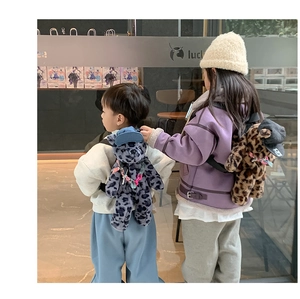 Rear view of kids wearing plush leopard print bear backpacks in brown and grey colors