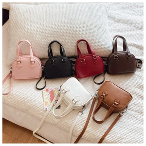 Close-up of colorful mini shell bags in litchi grain faux leather for kids