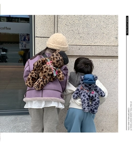 Detail of plush leopard print bear backpacks for kids in brown and blue colors