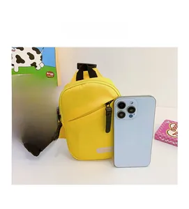 Close-up of yellow crossbody chest bag size comparison with a smartphone on white background