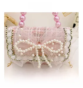 Detailed view of pink tweed kids bag with large pearl bow and lace trim embellishment