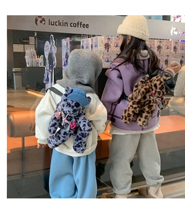 Detail of plush leopard print bear backpacks with colorful chains for kids