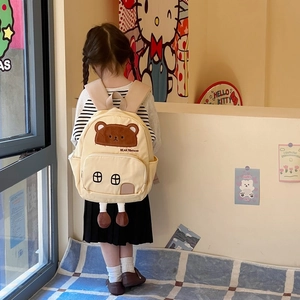 Cute beige cartoon bear backpack for toddlers with house-shaped pocket and 3D legs detail