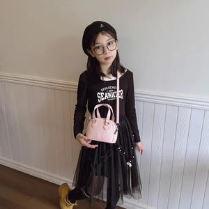 Pink lychee leather shell bag for kids featuring dual handles and adjustable shoulder strap