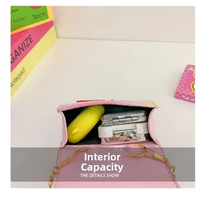 Internal view of pink sequin girl's bag showing storage for mirror and headphones