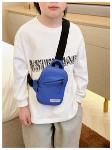 Detail of blue nylon kids chest bag with adjustable strap and TONGHUO logo patch