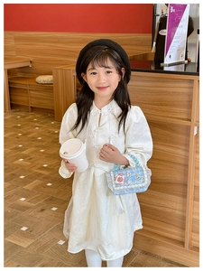Detail of a white Chinese style dress for girls with elegant pearl flower handbag