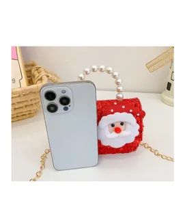 Mini red sequin Christmas bag with pearl handle shown next to a phone for scale