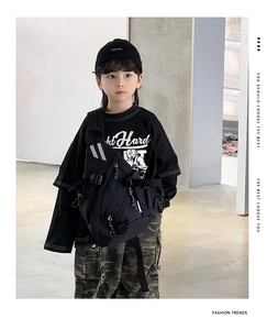 Detail of children's tactical chest bag with reflective strips and durable nylon fabric