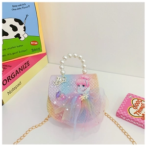 Detail of rainbow gradient girl's bag with 3D mesh skirt and pearl handle