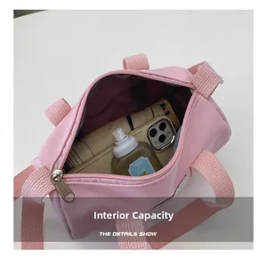 Detail shot of pink canvas bucket bag showing interior space for phone and umbrella