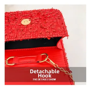 Detail of red sequin handbag showing the detachable golden chain hook and magnetic clasp
